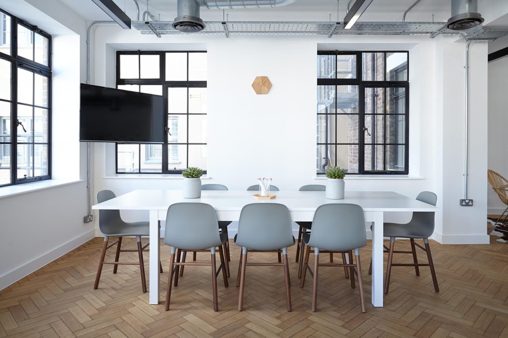 An empty meeting room with a long table and chairs