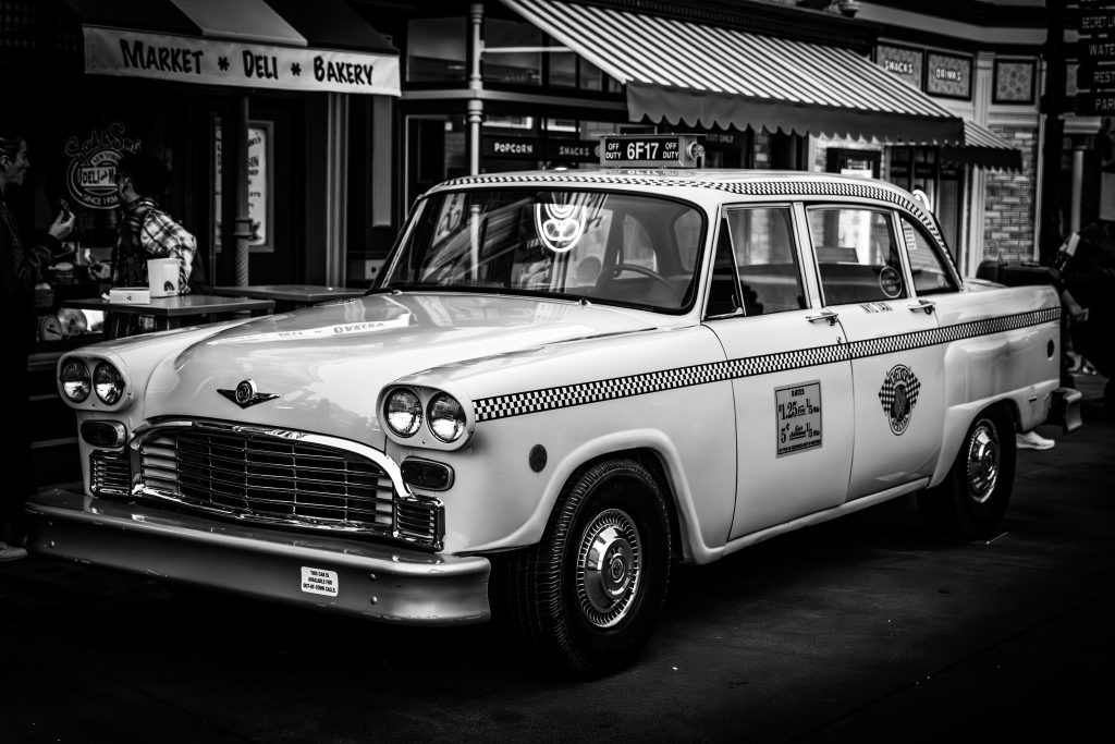 A vintage taxi parked on a city street